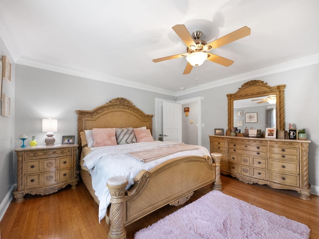 bedroom featuring ceiling fan, hardwood / wood-style flooring, and ornamental molding