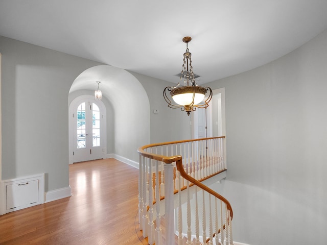 hallway featuring light wood-type flooring and french doors