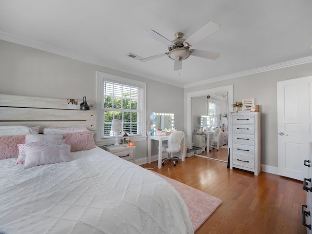 bedroom with ceiling fan, ornamental molding, and dark hardwood / wood-style floors