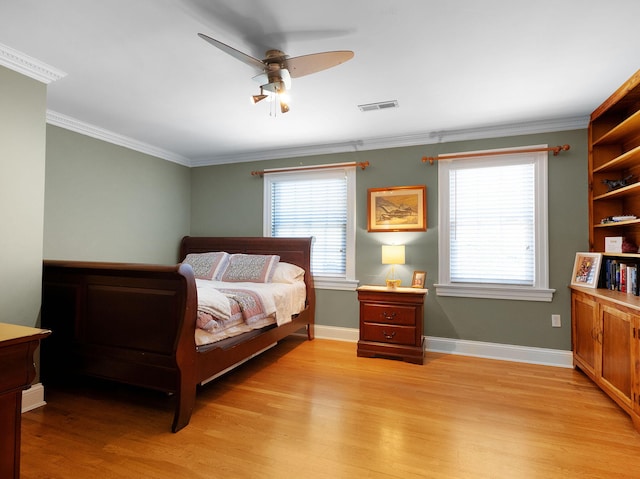 bedroom featuring ornamental molding, ceiling fan, and light hardwood / wood-style floors