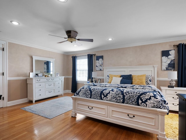 bedroom featuring ceiling fan, hardwood / wood-style floors, and crown molding