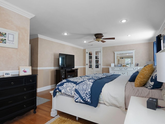 bedroom with ceiling fan, hardwood / wood-style flooring, and crown molding