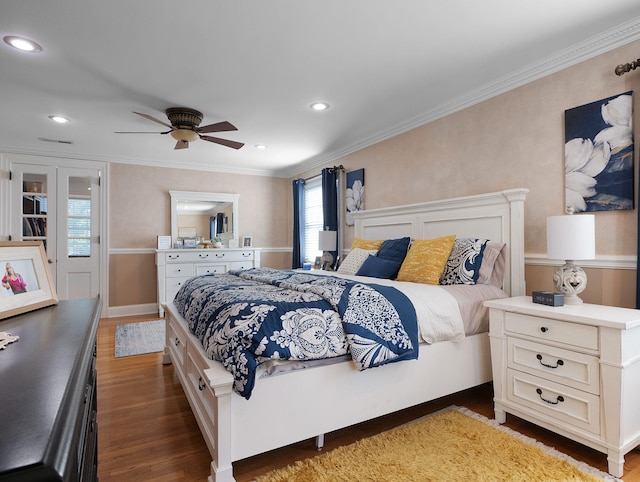 bedroom featuring ceiling fan, crown molding, and dark hardwood / wood-style floors