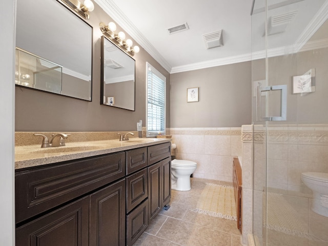 bathroom featuring tile walls, ornamental molding, toilet, a shower with door, and vanity