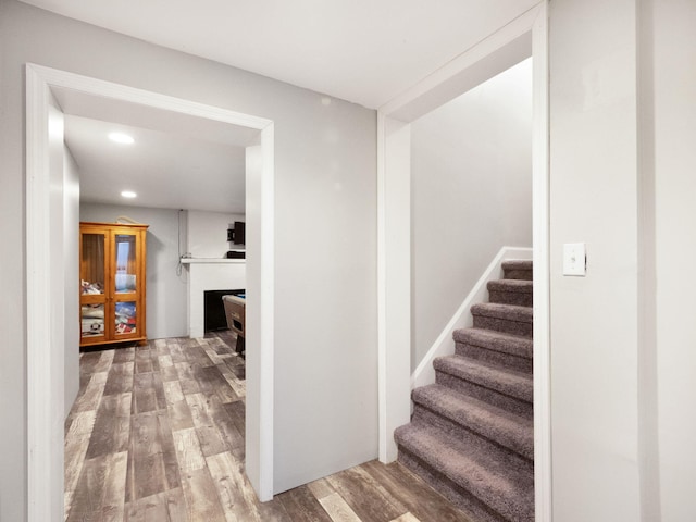 stairs with hardwood / wood-style floors