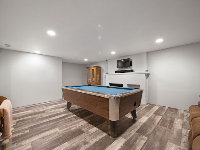 playroom with pool table, a fireplace, and hardwood / wood-style floors