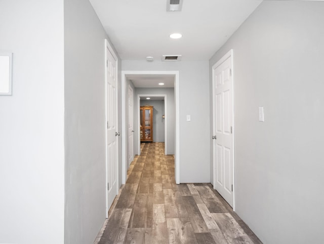 corridor featuring hardwood / wood-style floors