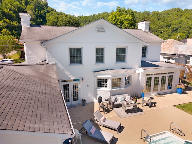 back of house with french doors, an outdoor hangout area, and a patio