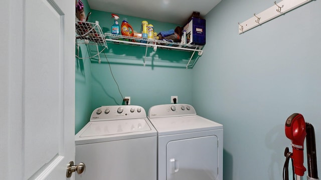 clothes washing area with washing machine and dryer