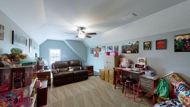 carpeted office space featuring vaulted ceiling and ceiling fan