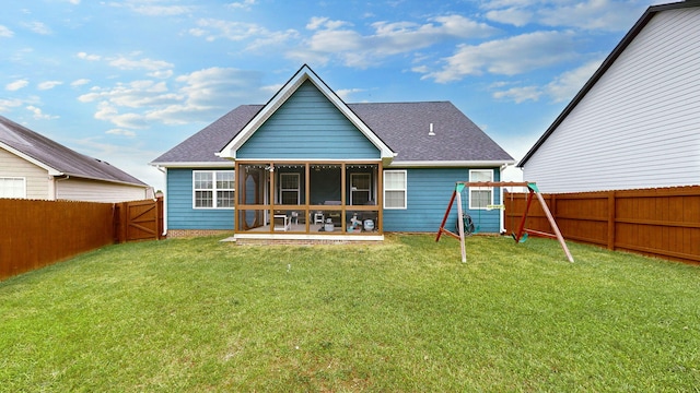 rear view of house featuring a patio area, a yard, and a playground