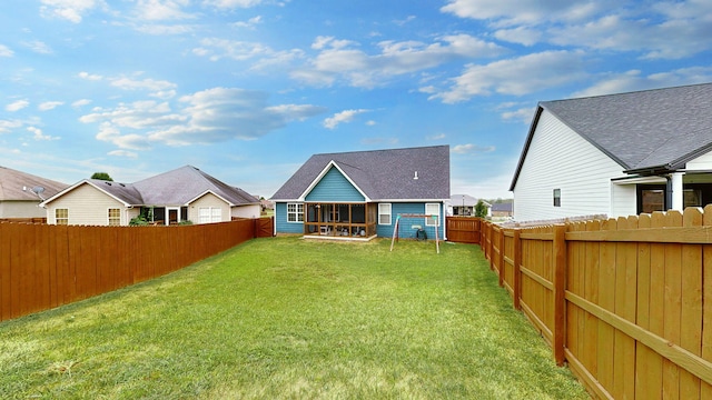 rear view of house with a patio and a yard