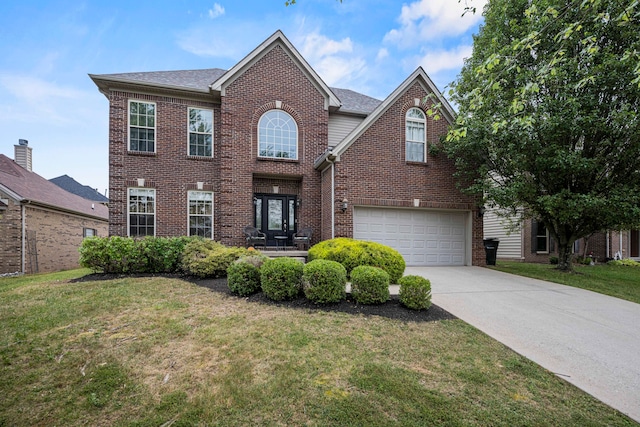 view of front of home featuring a garage and a front lawn