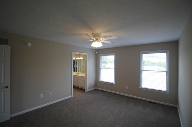 unfurnished room featuring dark carpet and ceiling fan