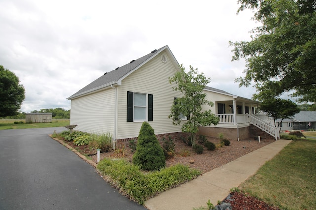 view of side of property with covered porch