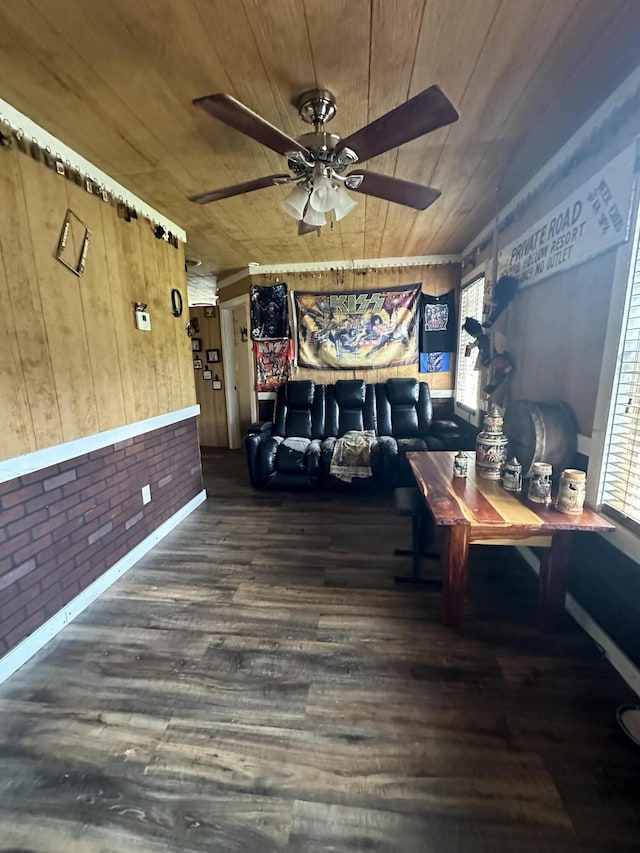 unfurnished living room featuring ceiling fan, plenty of natural light, brick wall, and wooden ceiling