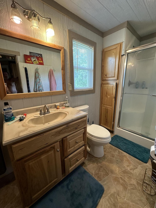 bathroom with toilet, walk in shower, and vanity