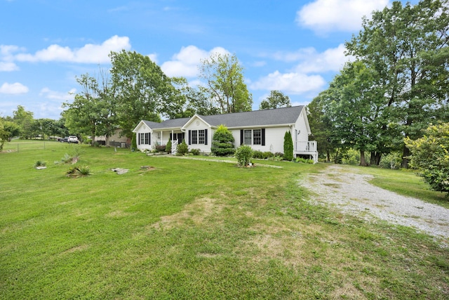 ranch-style house with driveway and a front yard