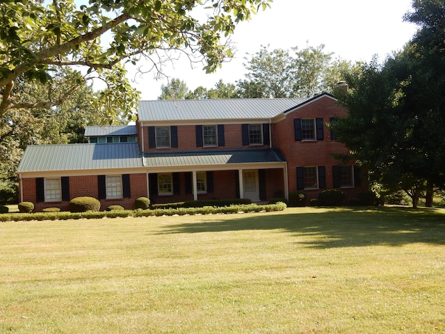 colonial inspired home with a front lawn