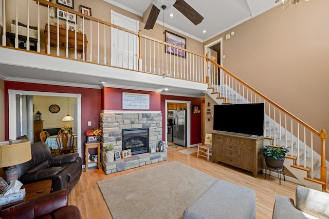 983 Short Town Rd, Liberty, KY 42539 - living area featuring stairs, a towering ceiling, wood finished floors, ceiling fan, and ornamental molding