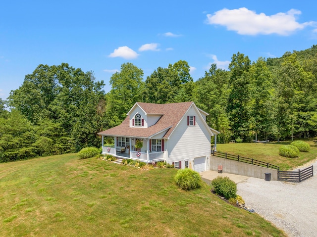 983 Short Town Rd, Liberty, KY 42539 - cape cod-style house featuring driveway, covered porch, fence, a front lawn, and a garage