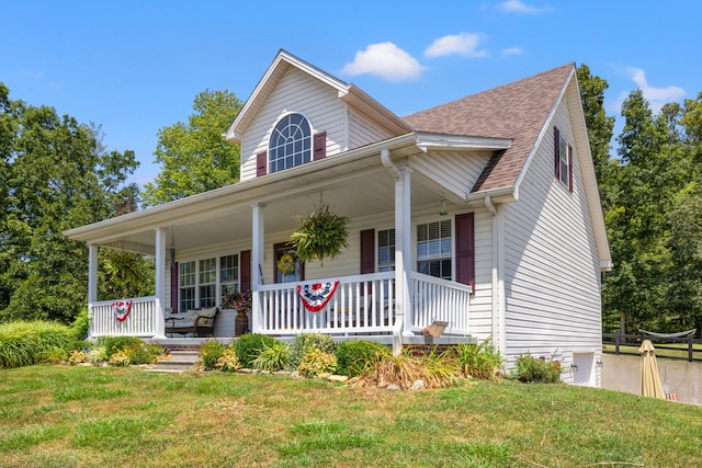 view of front of property with covered porch and a front yard