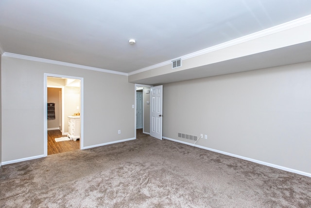 unfurnished bedroom with ornamental molding, carpet floors, and ensuite bathroom