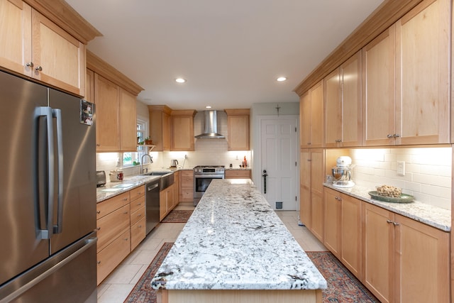 kitchen featuring a kitchen island, stainless steel appliances, light stone countertops, wall chimney exhaust hood, and decorative backsplash