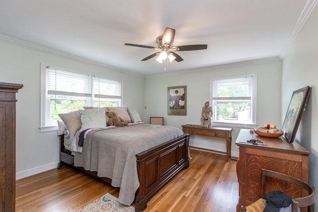 bedroom with light hardwood / wood-style flooring, ceiling fan, and crown molding