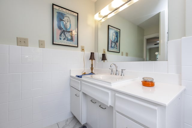 bathroom featuring vanity, decorative backsplash, tile walls, and tile patterned flooring