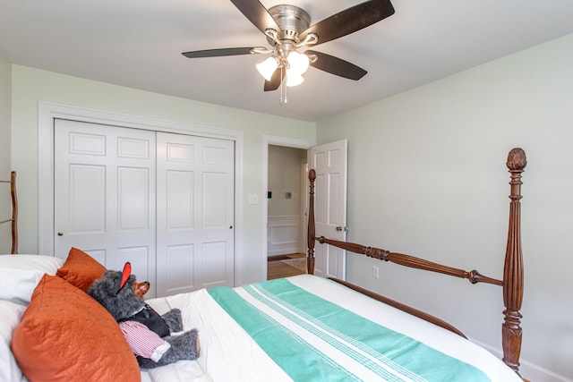 bedroom with ceiling fan, a closet, and wood-type flooring