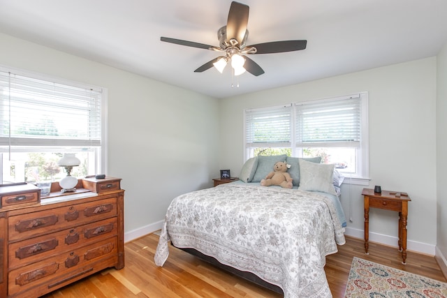 bedroom with light hardwood / wood-style flooring and ceiling fan