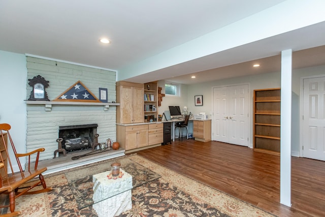 living room with wood walls, a fireplace, and wood-type flooring