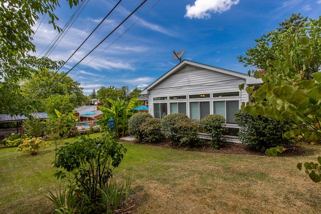 view of side of home featuring a lawn