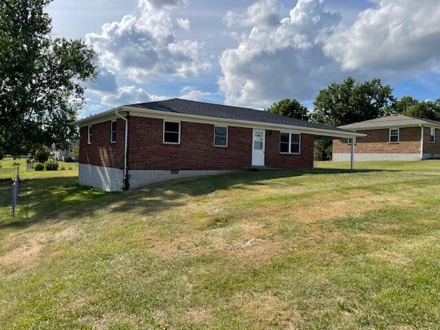 rear view of house with a yard