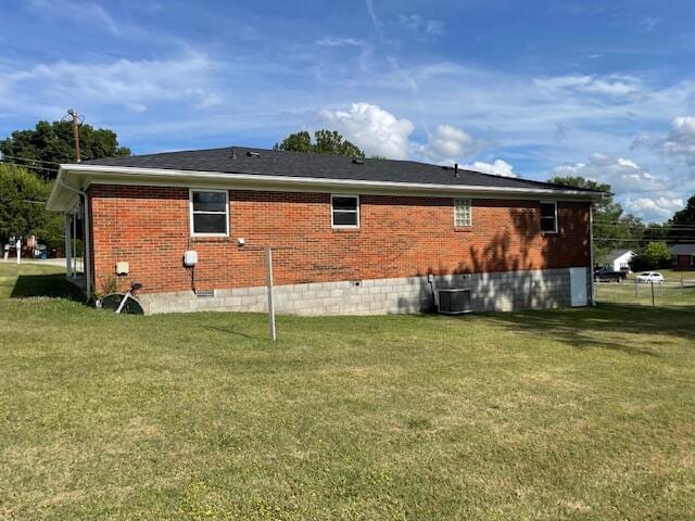 view of property exterior with a lawn and cooling unit