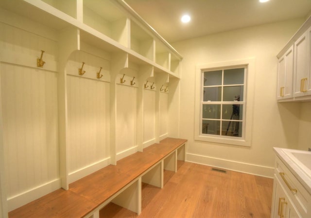 mudroom with light hardwood / wood-style floors