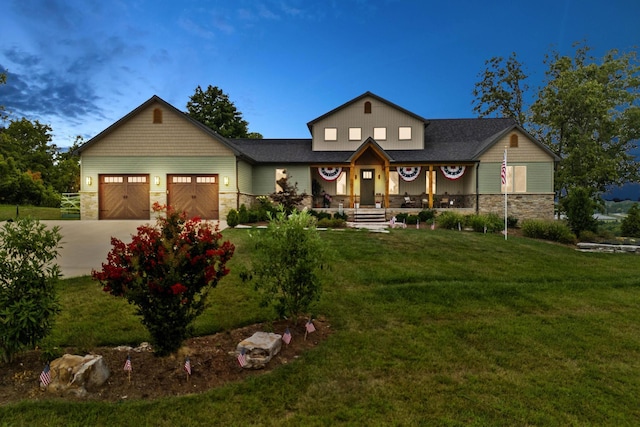 view of front facade with a front lawn, an attached garage, stone siding, and concrete driveway