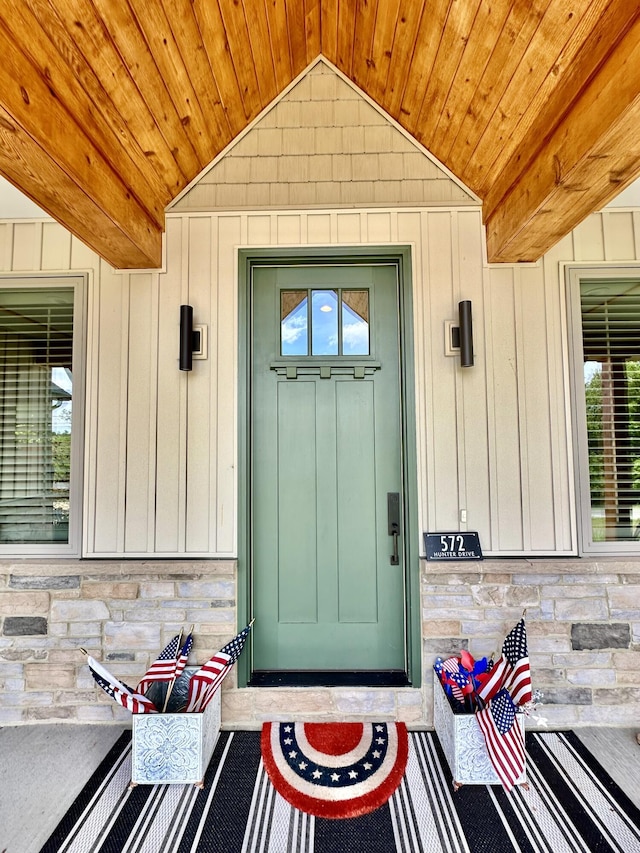 entrance to property with stone siding and board and batten siding