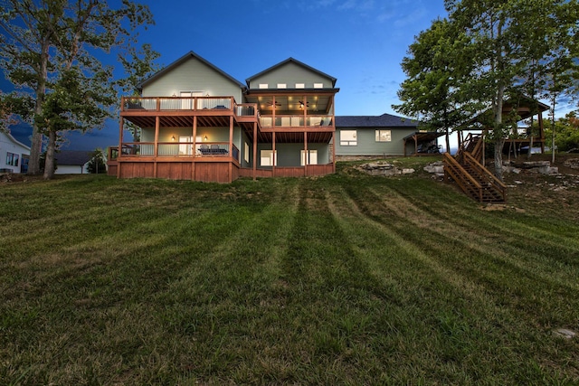 rear view of property featuring stairs, a yard, and a wooden deck