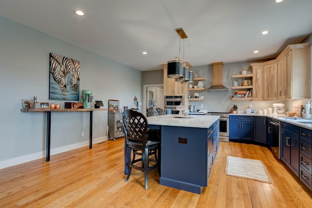 kitchen featuring blue cabinetry, light countertops, appliances with stainless steel finishes, wall chimney exhaust hood, and open shelves