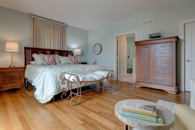 bedroom featuring visible vents and light wood-style floors