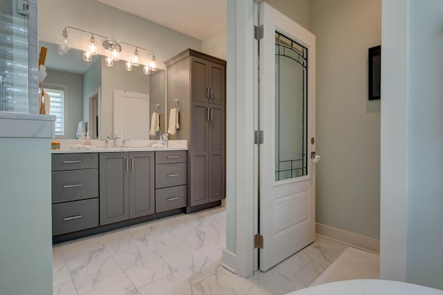 bathroom featuring marble finish floor, vanity, and baseboards