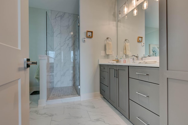 full bathroom with double vanity, baseboards, marble finish floor, and a shower stall