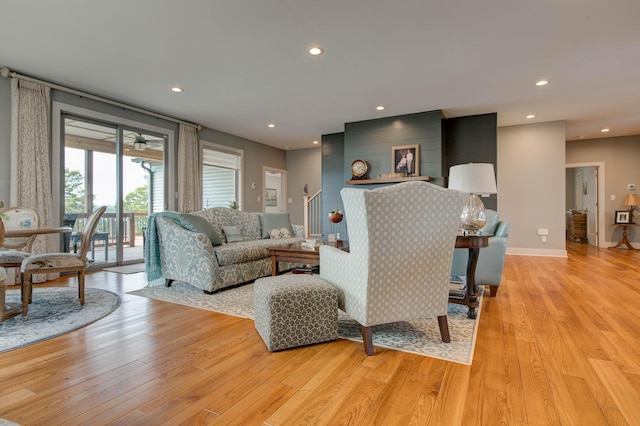 living area featuring recessed lighting, light wood-style floors, and baseboards