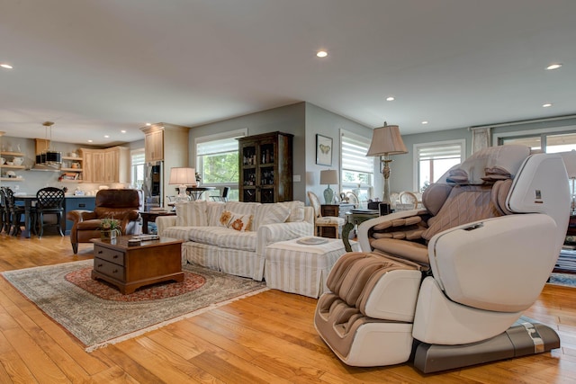 living room featuring recessed lighting, light wood-type flooring, and a wealth of natural light