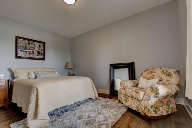 bedroom with baseboards and wood finished floors