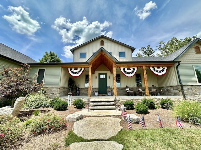 view of front of property with stone siding and covered porch