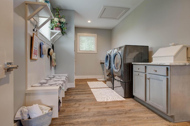 clothes washing area with washer and dryer, recessed lighting, light wood-style floors, baseboards, and attic access