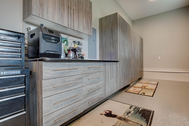 kitchen with light brown cabinets, modern cabinets, and a baseboard heating unit